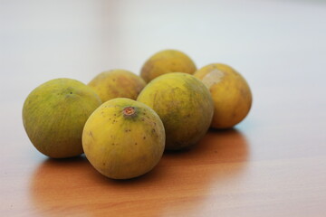 greenish yellow harp fruit isolated on money table has sweet and sour taste. Food concept photo.