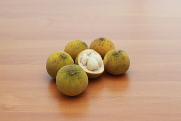 greenish yellow harp fruit isolated on money table has sweet and sour taste. Food concept photo.