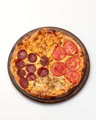 Pizza four seasons. Italian food. Pizza on wooden board, cut into portions. Isolate on white background. View from above. Copy space.