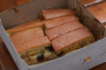 a dish called sweet martabak topped with raisins and bananas tastes sweet and is filling. made from flour dough. served warm. Food concept photo.