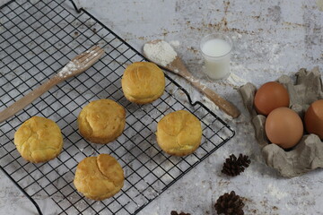 a traditional cake from Indonesia called kue sus filled with cream puffs. served on a cake rack. Food concept photo.