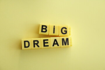 Big dream. The inscription in yellow cubes on a yellow background.