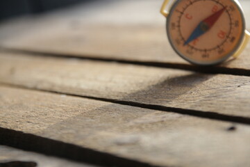 Vintage compass on wooden background