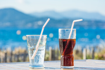 Scenic view of two glasses of cold beverages during hot summer day at the beach in south of France in Saint Tropez bay 