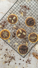 Small chocolate pie with almonds topping served on a cake rack, tastes sweet and savory. Food concept photo.