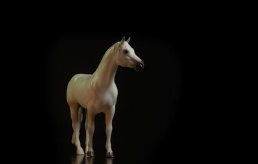 Fototapeta na wymiar Black toy horse isolated on black background