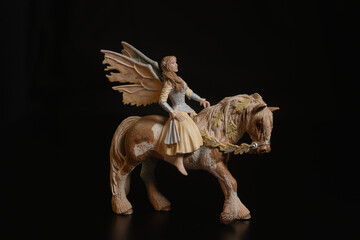 Black toy horse isolated on black background