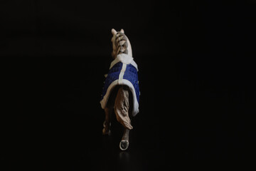 Black toy horse isolated on black background