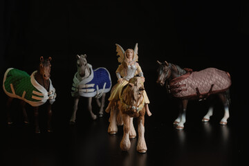 Black toy horse isolated on black background