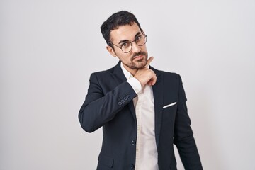 Handsome business hispanic man standing over white background cutting throat with hand as knife, threaten aggression with furious violence