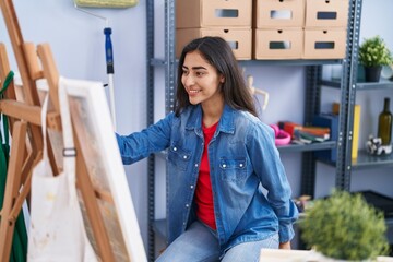 Young hispanic girl artist smiling confident drawing at art studio