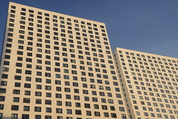 Fototapeta premium MOSCOW, RUSSIA -December 2022: Facades of new buildings in a residential complex in Butovo, Moscow, Russia. Modern style in architecture. House in a residential area of Moscow.