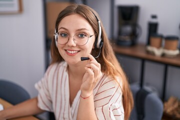 Young blonde woman call center agent smiling confident working at office