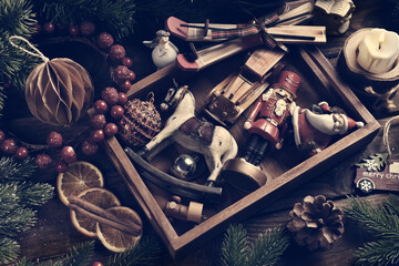 Vintage style Christmas toys and decors in wooden box top view with color effect