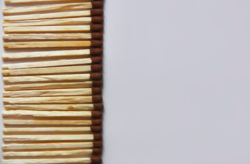 wooden matches with brown heads made of sulfur on a gray background
