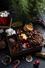 On the table there is a box with nine compartments in which nuts, cookies and spices are poured