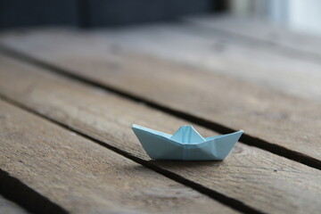 Beautiful paper boat on a vintage background.