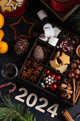 On the table there is a box with nine compartments in which nuts, cookies and spices are poured. On...