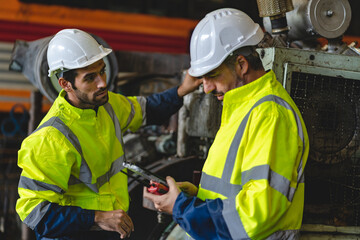 professional technician engineer with safety hard hat working to maintenance construction equipment in industrial factory, inspection man having manufacturing occupation job of production technology