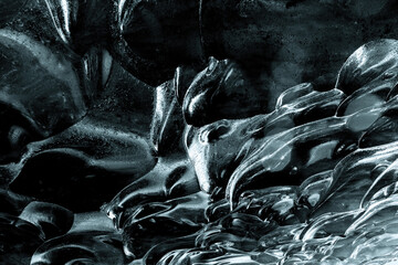 Glacial ice abstract background. Detail of the rippled blue ice of an ice cave in southern Iceland