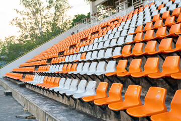 Orange white stadium chairs in outdoor field