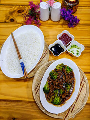 Meat Brocolli with rice and sauces served in dish isolated on table top view of arab food