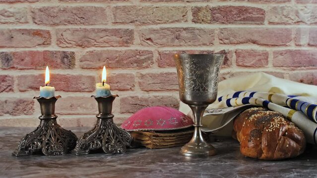 It is Shabbat Shalom culture traditional symbol religious of Saturday challah bread wine candles on holiday table.