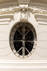Pretty vertical oeil-de-boeuf window in baroque style building, Santiago, Chile