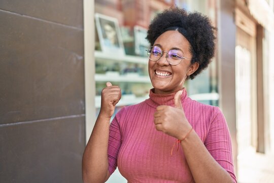African american woman smiling confident doing ok sign with thumbs up at street