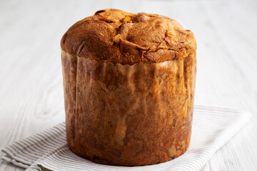 Homemade Italian Panettone with Raisins and Large Pieces of Candied Fruit, side view.