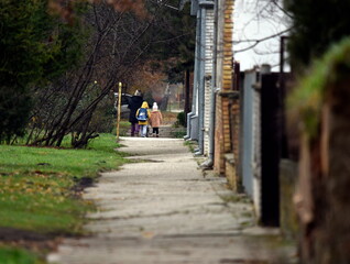 Fototapeta na wymiar Mother taking her two kids to school.