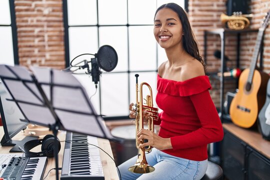 Young African American Woman Musician Playing Trumpet At Music Studio