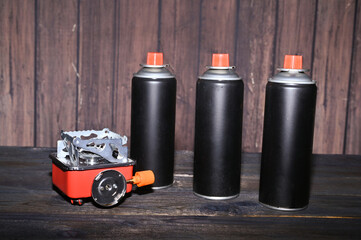 tourist gas burner and spray cans on the table