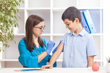 vaccination of children, a little boy at a doctor's appointment, an injection in the arm