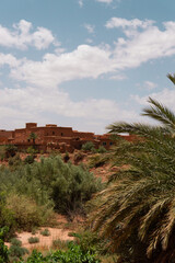 Ait Ben Haddou city, desert village with palms and yellow stones and rocks, castle in sahara desert, canyon, Morocco