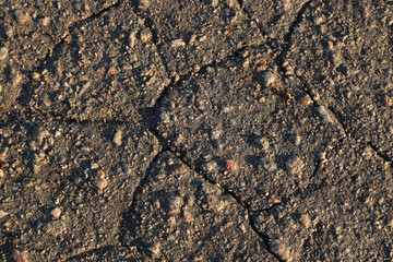 The cracked asphalt background texture
