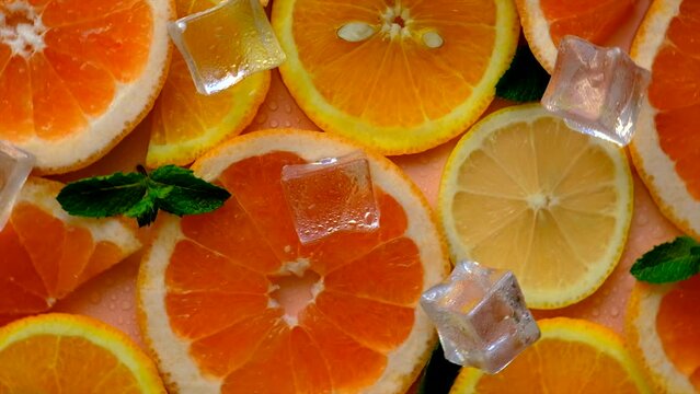 Citruses and ice on a yellow background. Selective focus.
