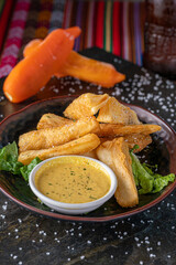 Yuquitas fritas, Peruvian yuca fries with dipping sauce.