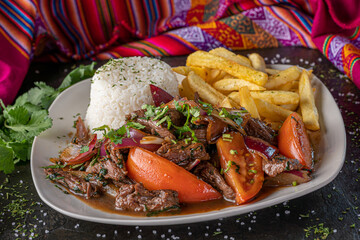 Lomo saltado, a traditional Peruvian stir fry that combines marinated strips of sirloin with...