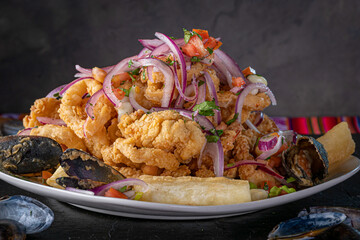 Jalea Mixta - fried seafood dish from Peru with squid, mussells and fish.