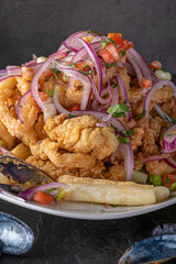 Jalea Mixta - fried seafood dish from Peru with squid, mussells and fish.