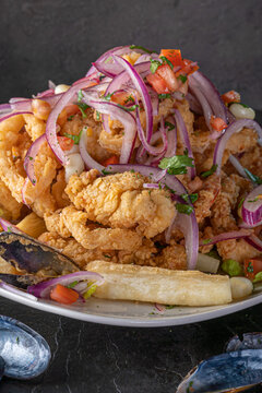 Jalea Mixta - fried seafood dish from Peru with squid, mussells and fish.