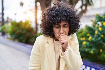 Fototapeta na wymiar Young middle east woman executive coughing at park