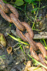 An old rusty anchor chain. Fixing the boat on the pier. Rusty iron construction.