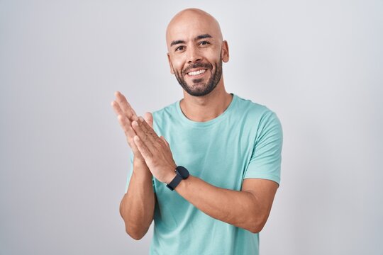 Middle Age Bald Man Standing Over White Background Clapping And Applauding Happy And Joyful, Smiling Proud Hands Together