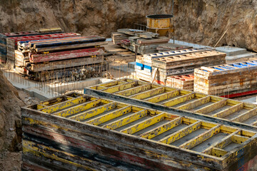 Construction site. An industrial facility under construction. Concrete formwork with a folding mechanism on construction site. The clamp connects the formwork panels close-up.