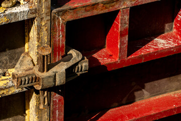 Construction site. An industrial facility under construction. Concrete formwork with a folding mechanism on construction site. The clamp connects the formwork panels close-up.