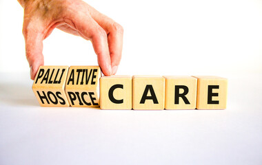Palliative or hospice care symbol. Concept word Palliative care Hospice care on wooden cubes. Doctor hand. Beautiful white table white background. Medical palliative hospice care concept. Copy space.