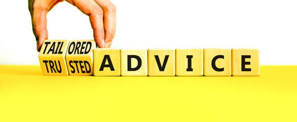 Tailored or trusted advice symbol. Concept words Tailored advice and Trusted advice on wooden cubes. Businessman hand. Beautiful white background. Business tailored trusted advice concept. Copy space.