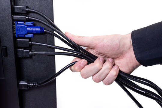 IT engineer Man hand inserts cable into monitor. Man hand connecting the DVI cable for monitor to computer PC. VGA DVI DisplayPort and power cable. close up in the hands of an . isolated